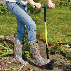Jardineer tool in use planting bulbs while standing to reduce back strain