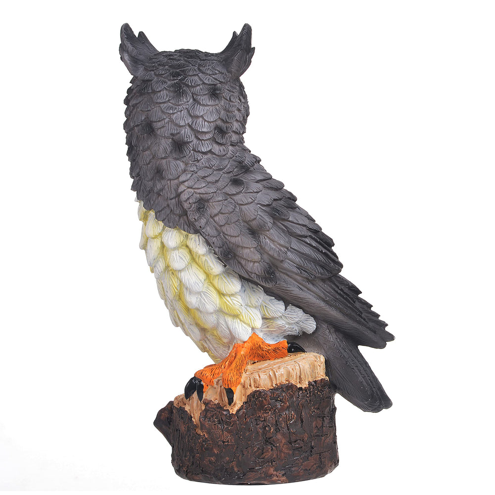 Jeelyfu owl placed in planter demonstrating compact size and garden protection benefit