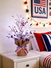 JEGERMIG tree lit at dusk casting warm patriotic glow ideal for evening decoration