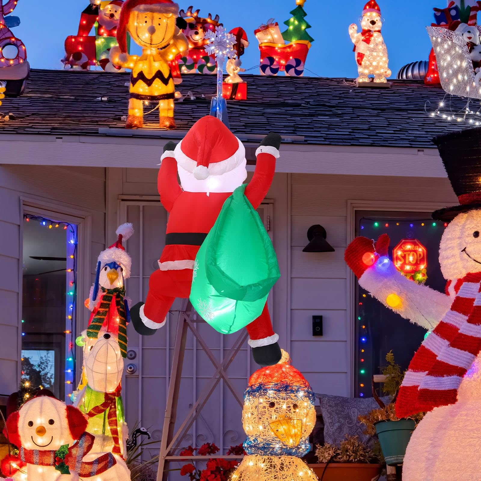 Jenaai climbing Santa mounted on a porch creating festive outdoor atmosphere