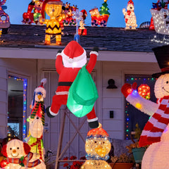Jenaai climbing Santa mounted on a porch creating festive outdoor atmosphere