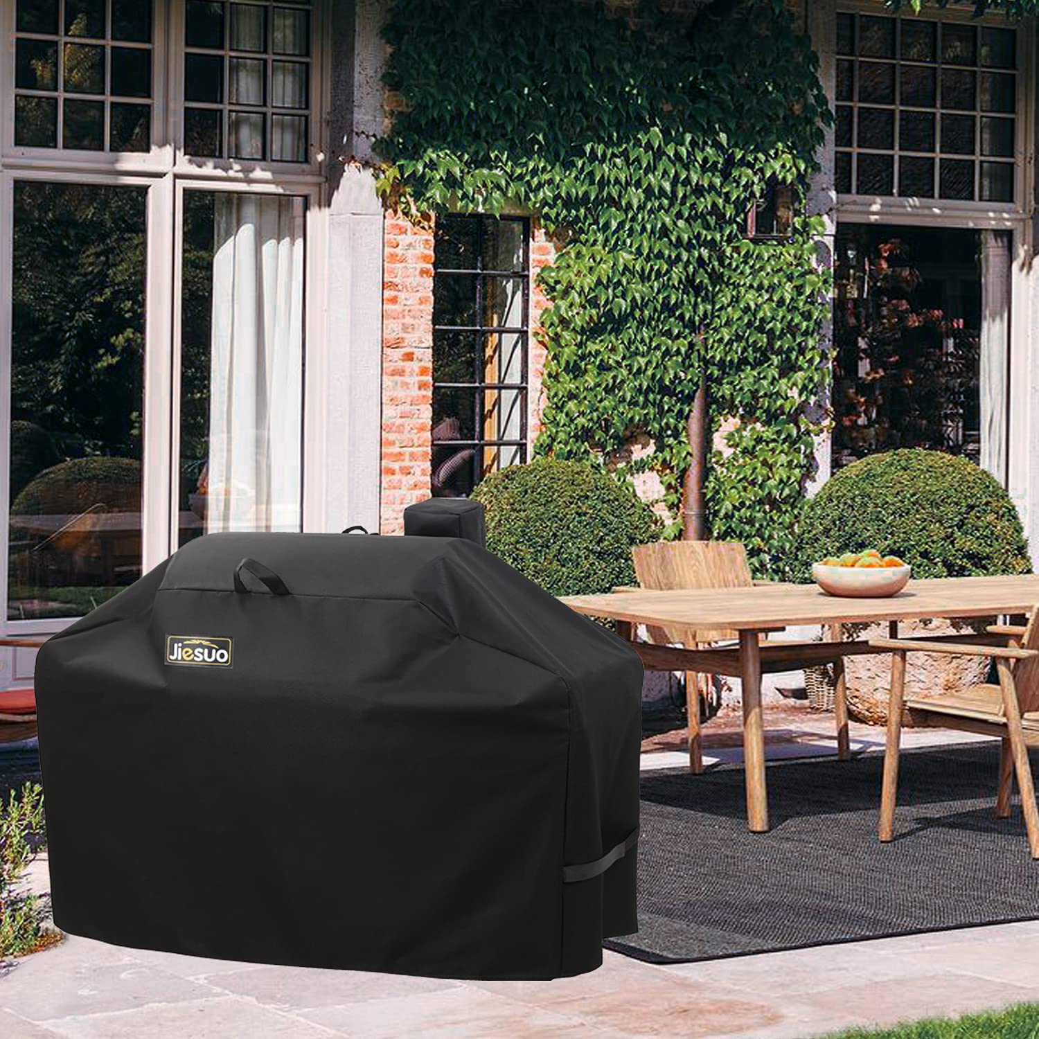 JIESUO cover in backyard lifestyle shot protecting grill from sun, rain, and dust