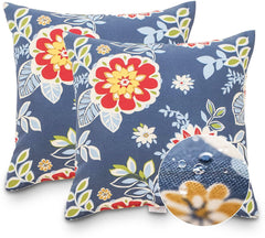 JMGBird pillows styled on a patio sectional adding botanical color and comfort