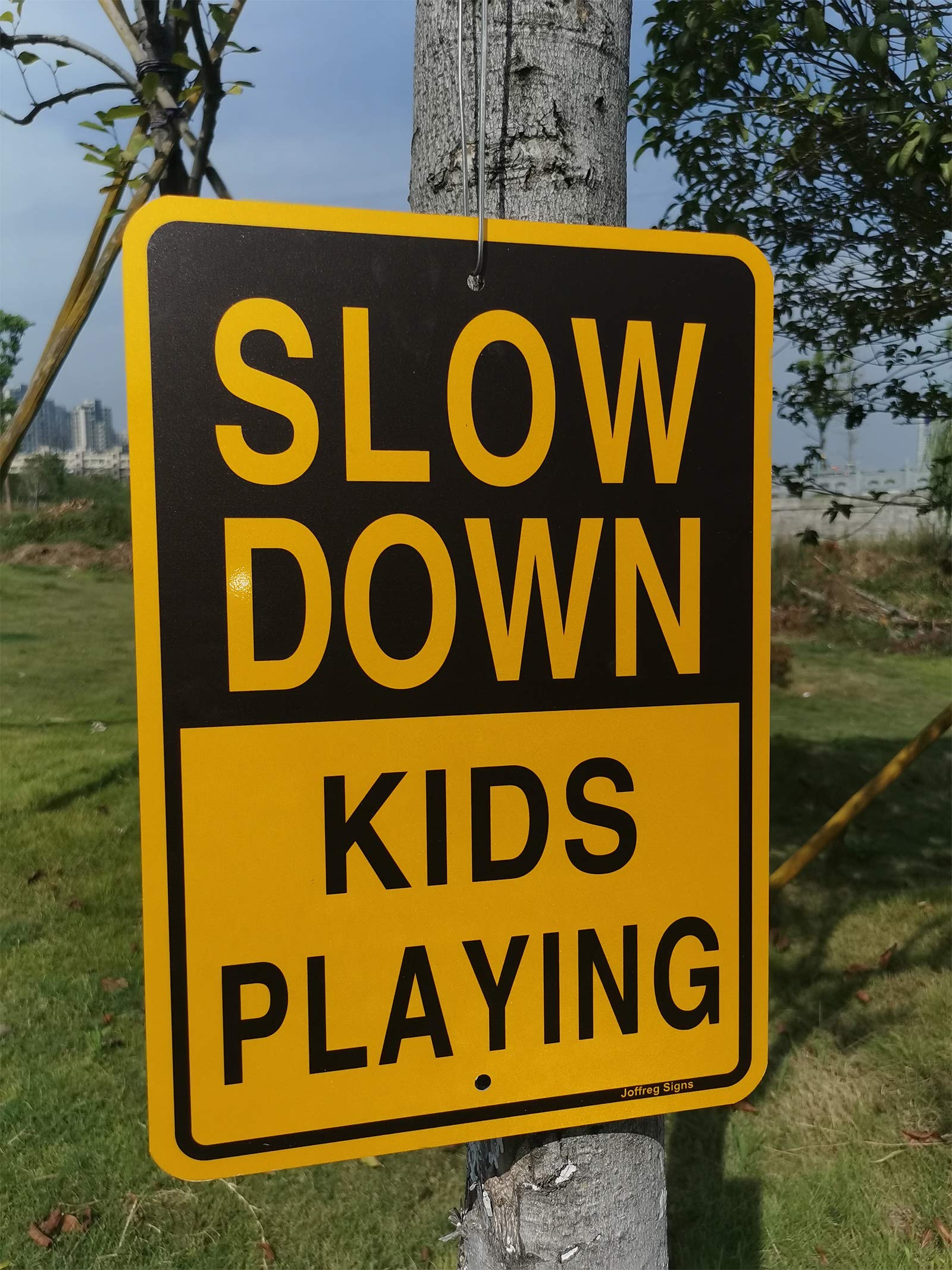 Joffreg sign held next to a hand showing practical size