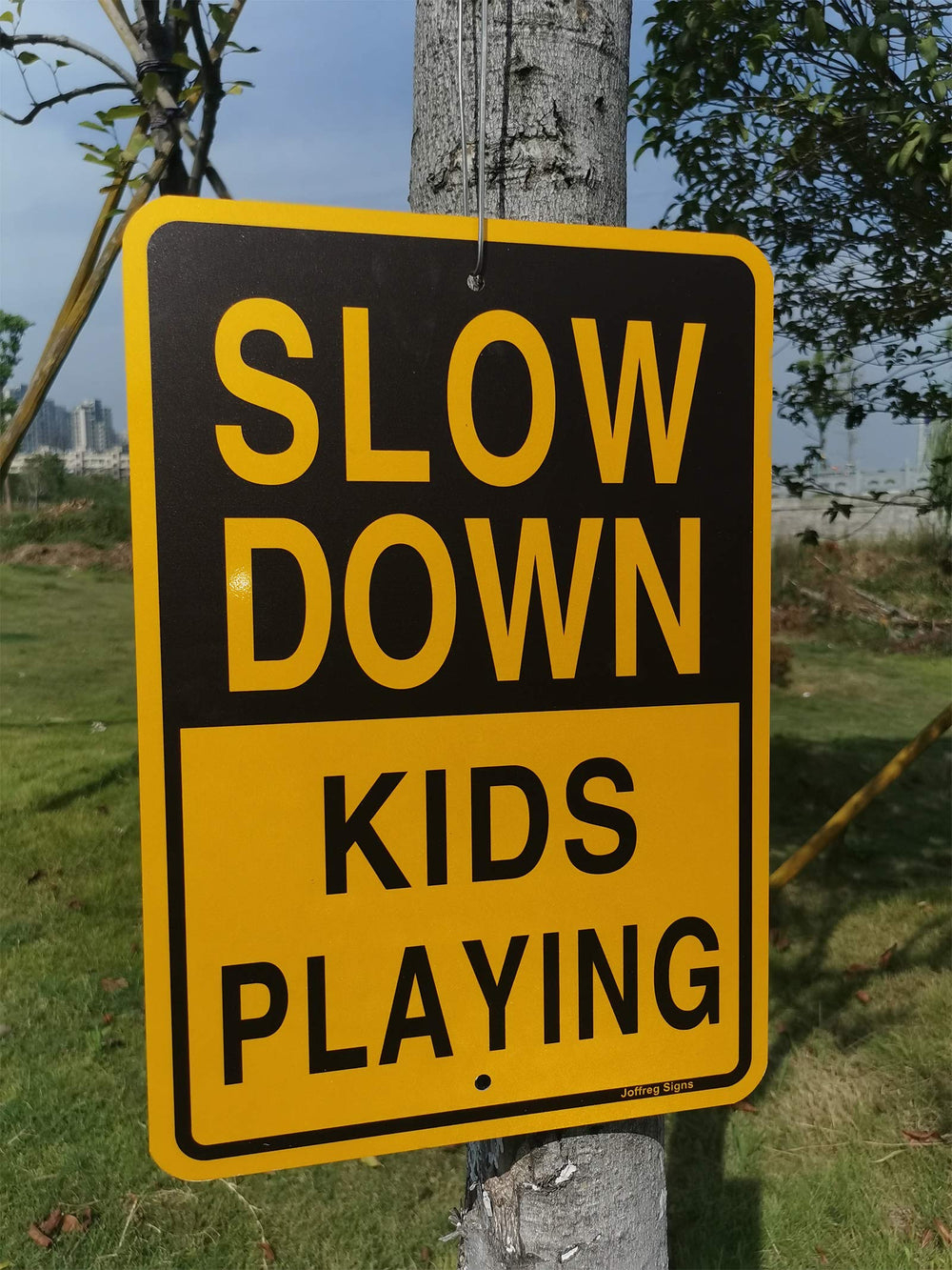 Joffreg sign held next to a hand showing practical size