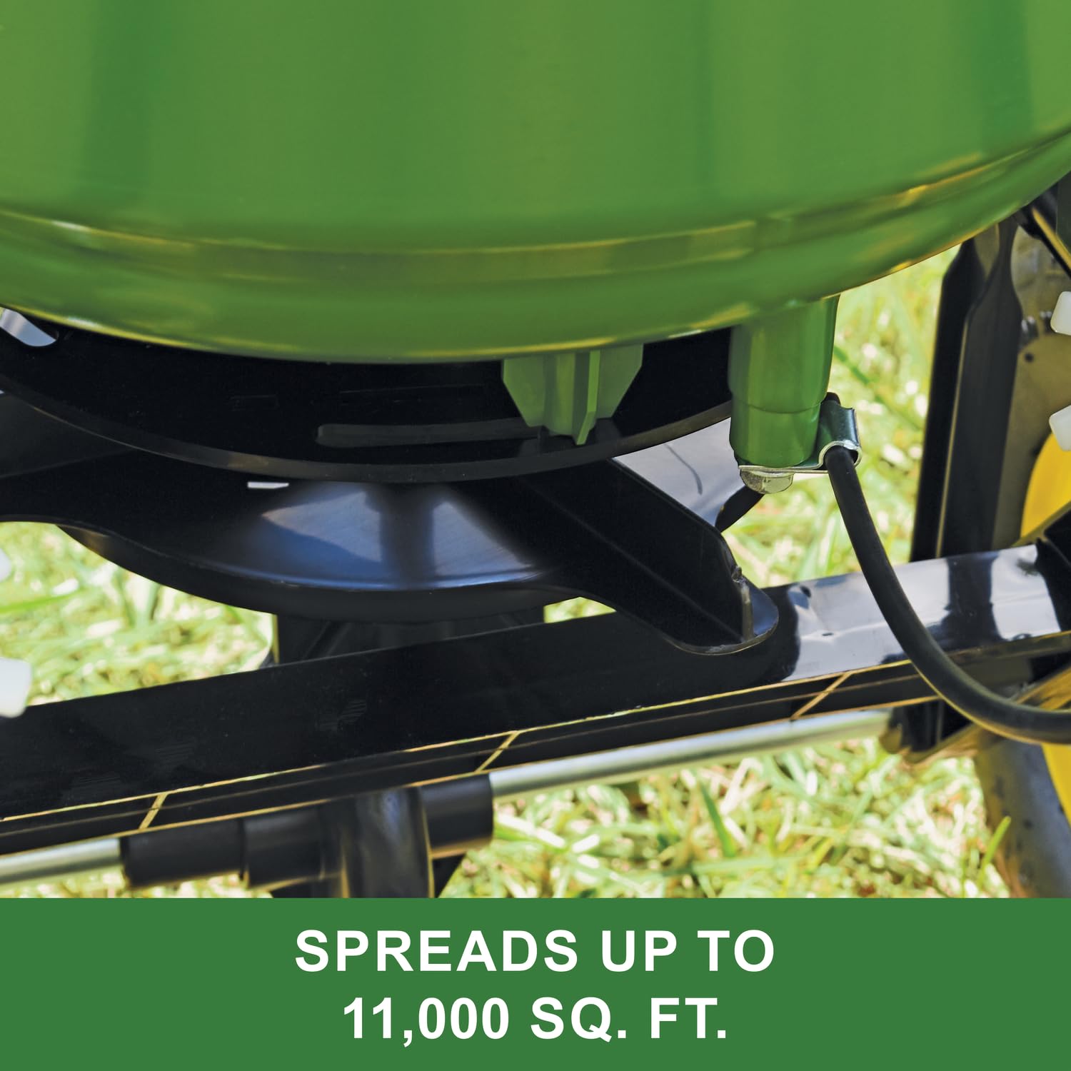 John Deere spreader beside yard tools showing size and capacity for scale