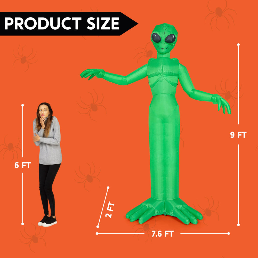 Joiedomi alien beside an adult for scale showing true 9 foot height