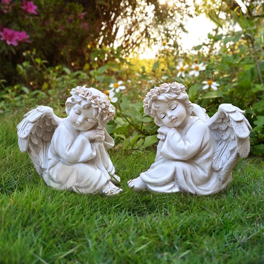 Juliahestia angel placed in flower bed enhancing plants and creating a memorial focal point