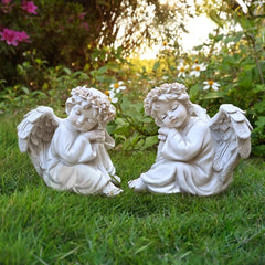 Juliahestia angel placed in flower bed enhancing plants and creating a memorial focal point