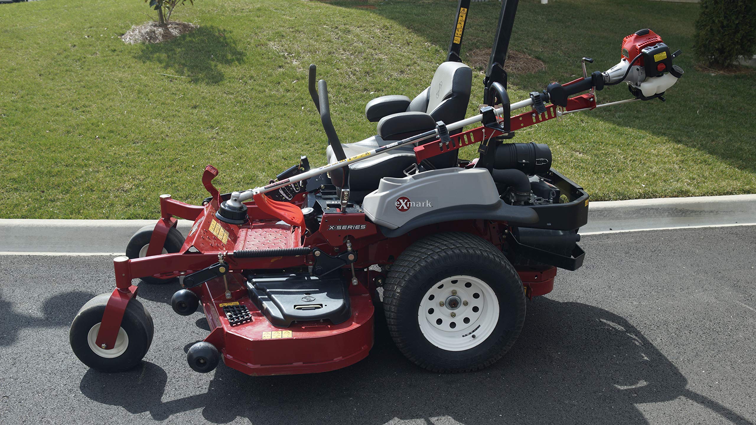 Jungle Jim's crew operating zero turn mower with ZTR-TR rack for jobsite efficiency