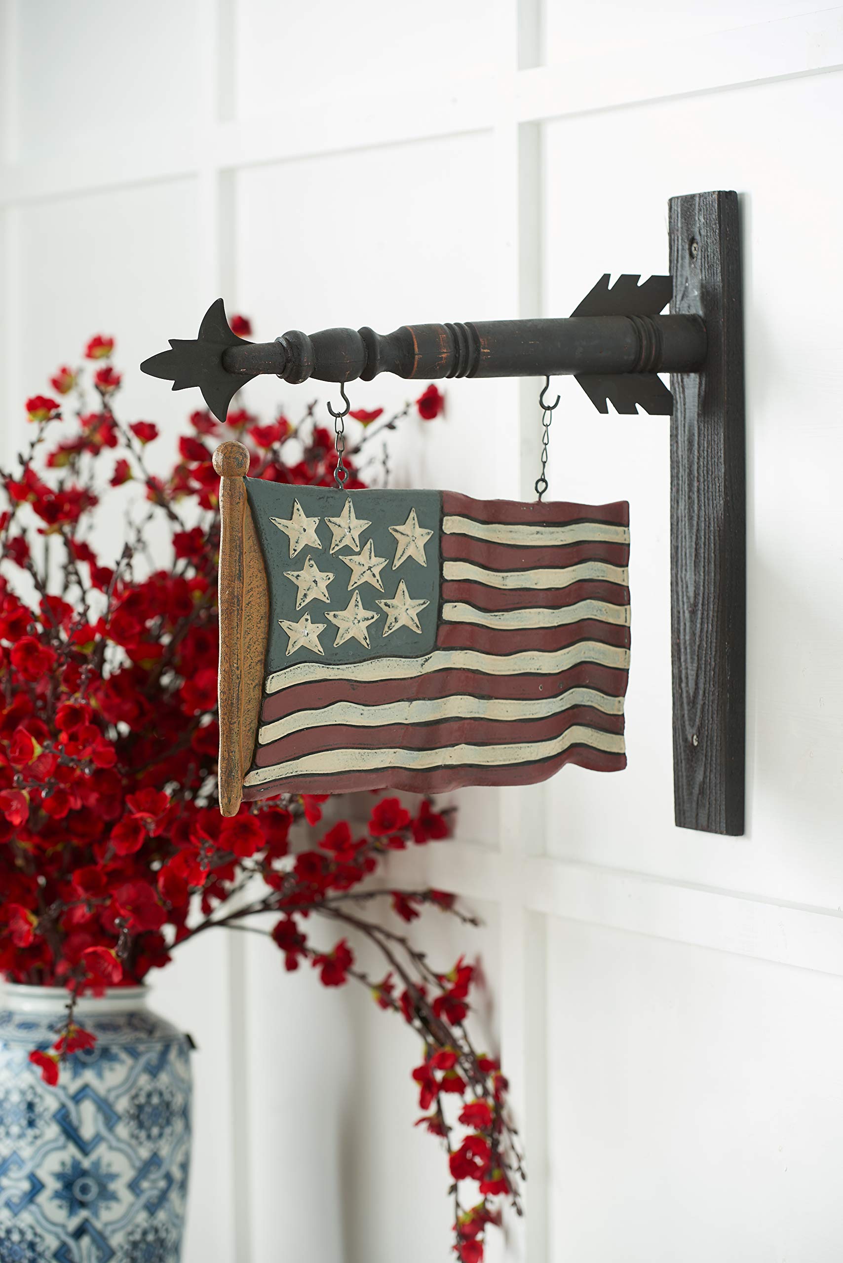 K&K Interiors carved flag arrow installed on a porch displaying easy seasonal styling