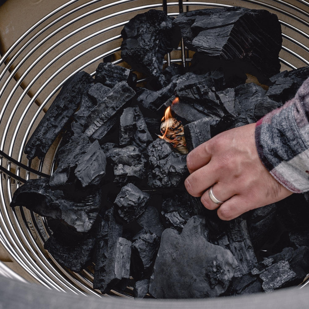 Kamado Joe basket being lifted from firebox demonstrating easy cleanup benefit