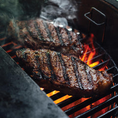 Kamado Joe cast-iron grate lifter close-up for safe removal and easy handling