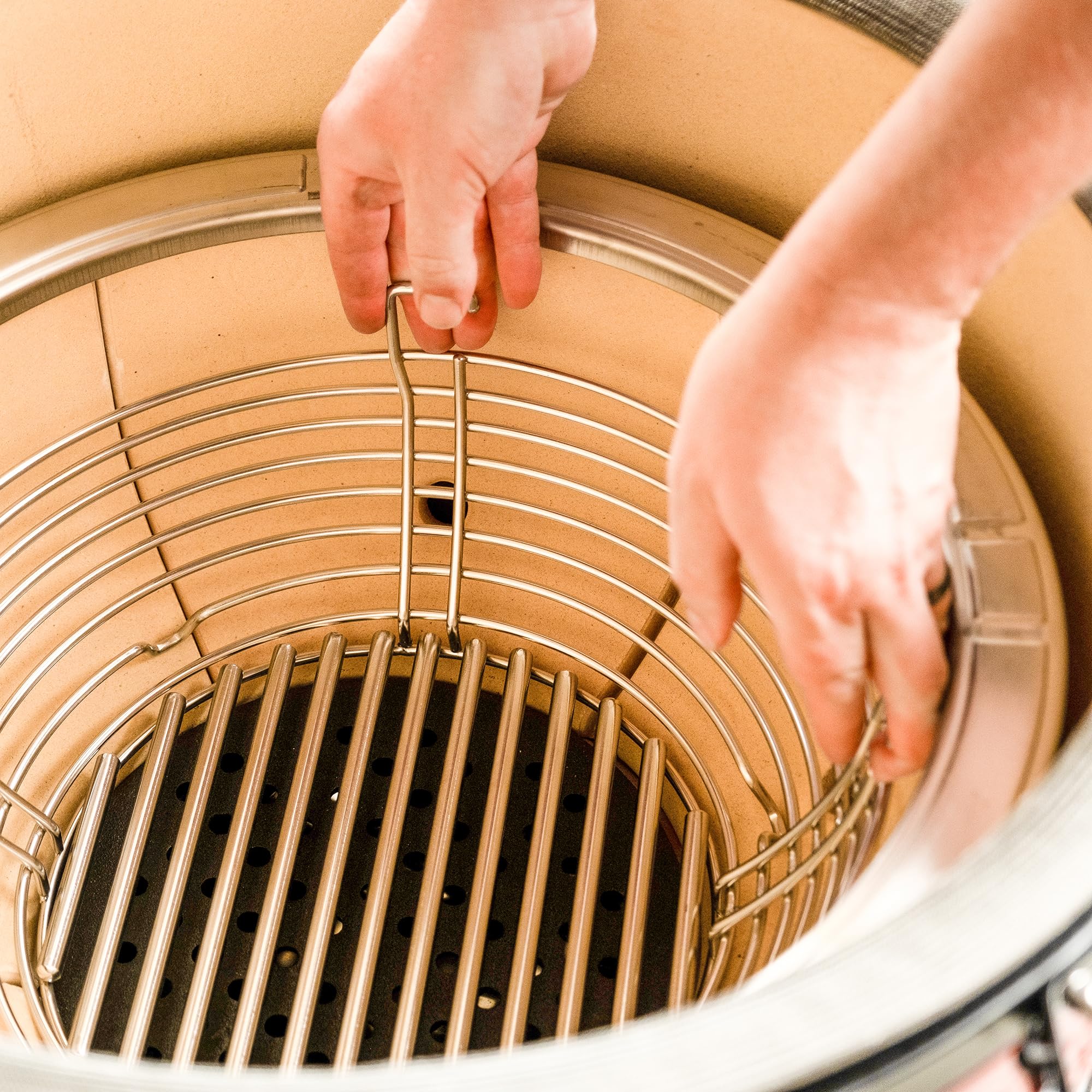 Kamado Joe stainless divider close-up highlighting dual-zone cooking control and reliable separation