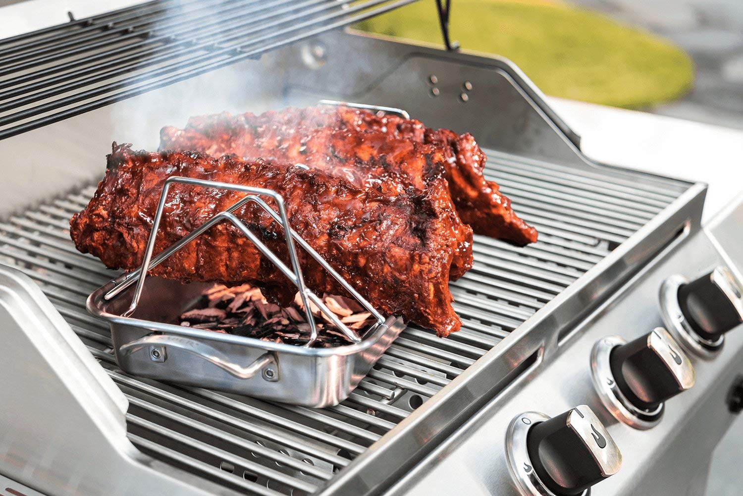 KAMaster rack loaded on backyard grill showing versatile outdoor cooking benefit