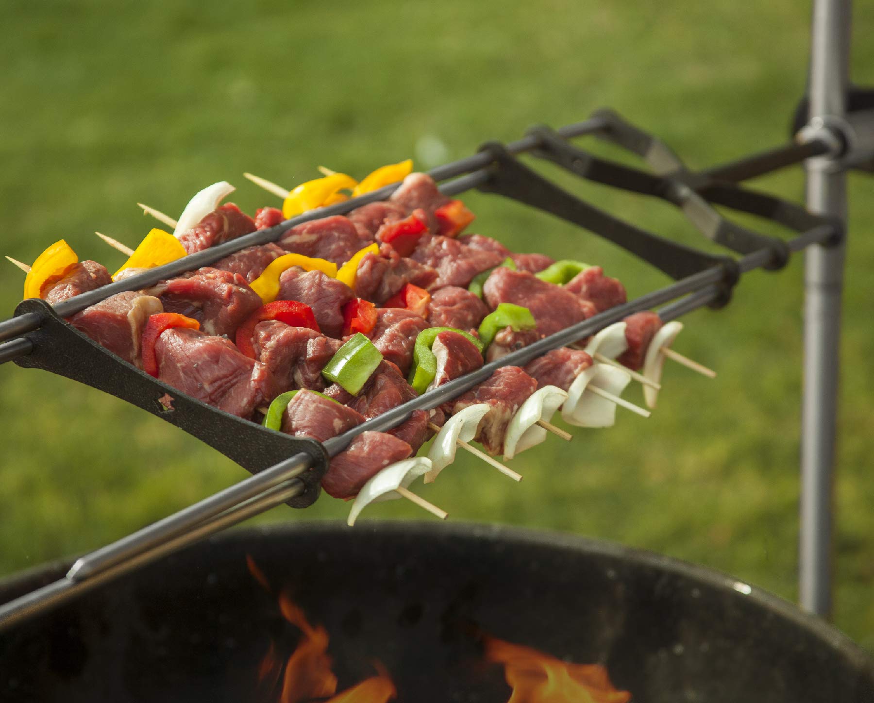 KANKA skewers balanced over a campfire showing portable outdoor grilling benefit