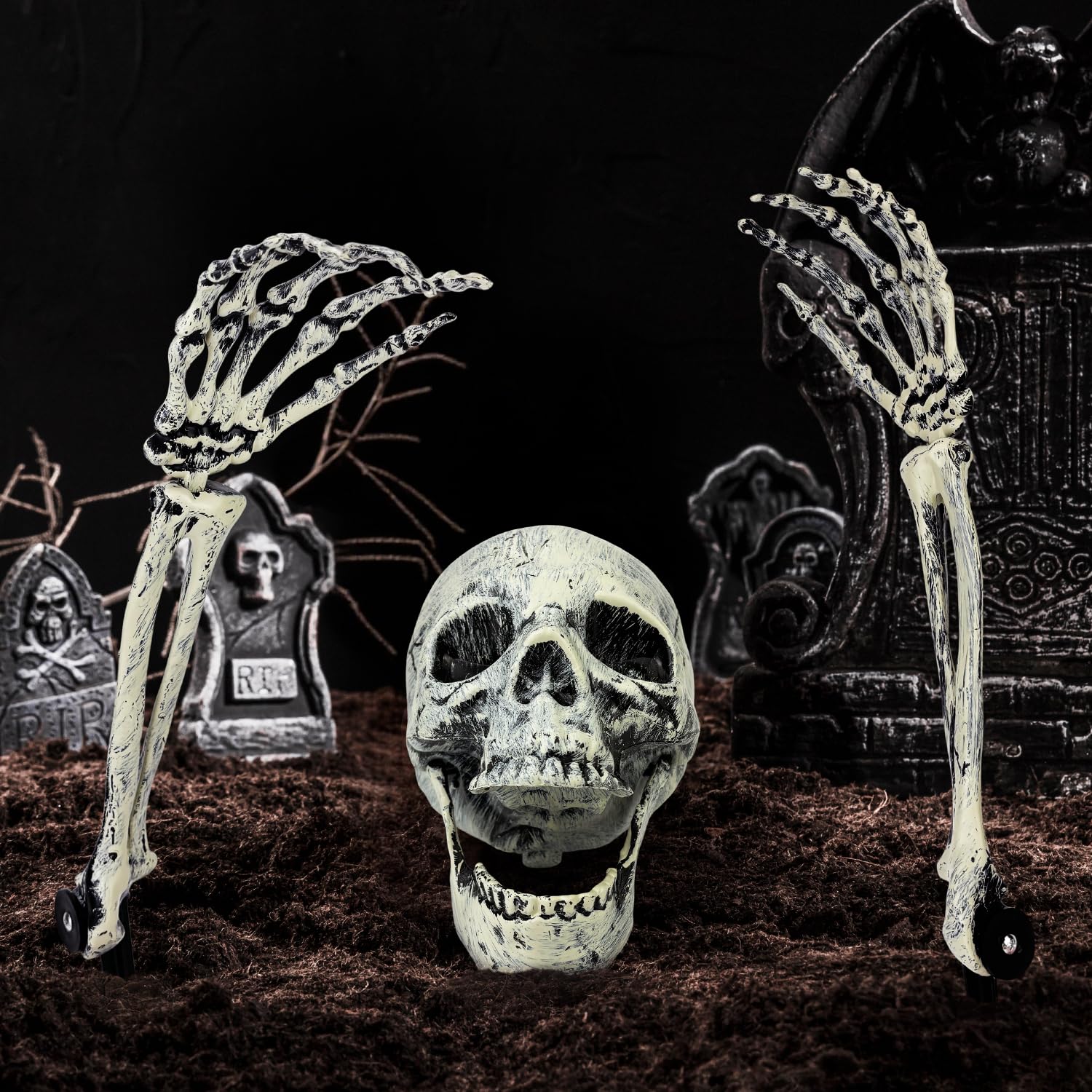 Kannove nighttime yard scene with spotlighted skeletons creating spooky atmosphere