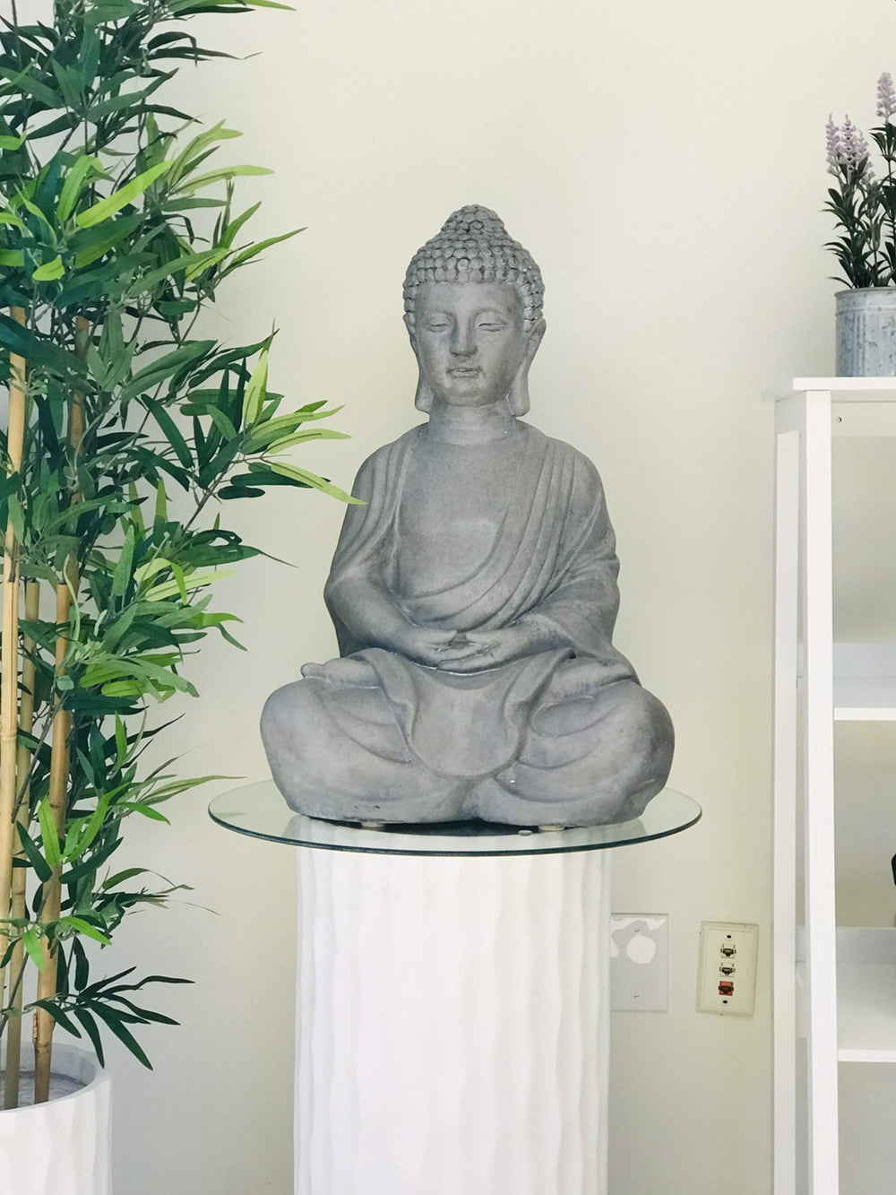 Kante Buddha staged in garden with plants demonstrating tranquil focal point benefit