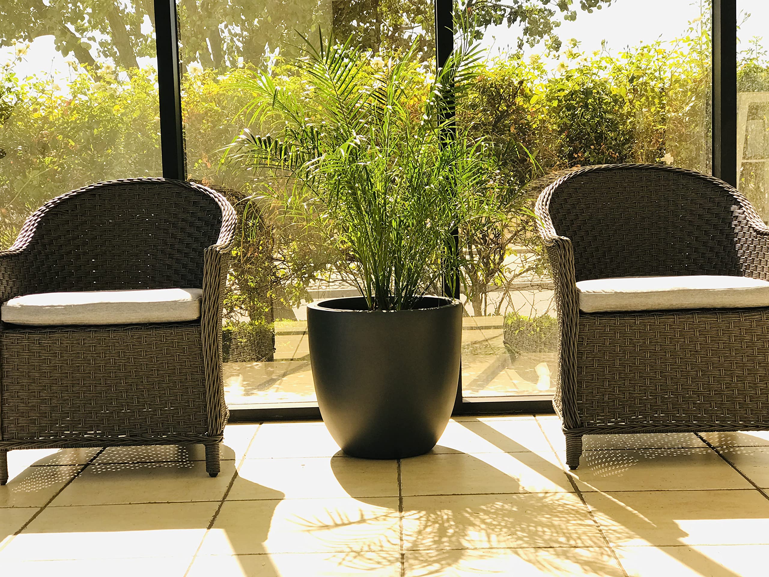 Kante planter on patio with mixed plants adding contemporary curb charm