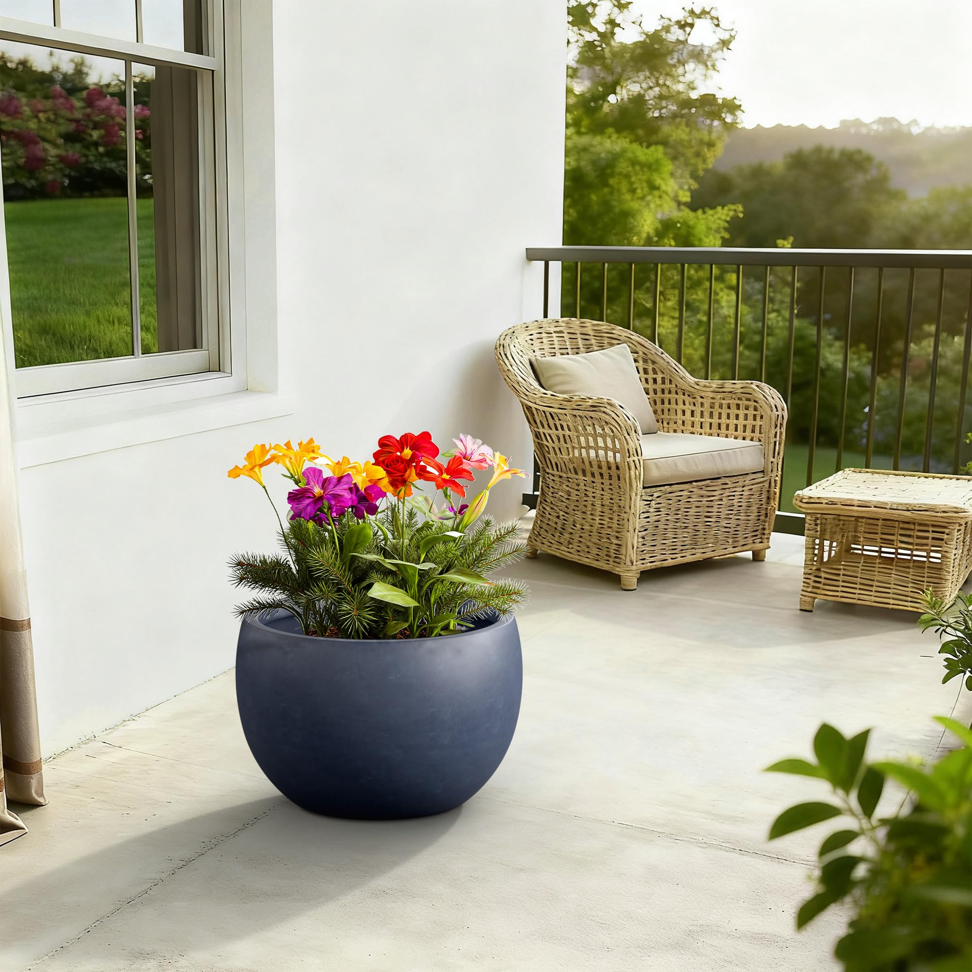 Kante charcoal planter in-use on patio with leafy plants adding focal interest