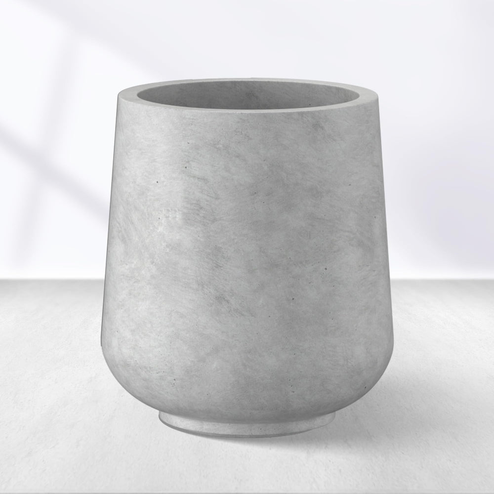 Kante planter front view showing pale gray concrete finish and modern curve, boosts curb appeal