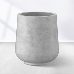 Kante planter front view showing pale gray concrete finish and modern curve, boosts curb appeal