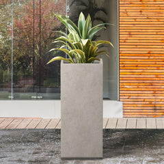 Kante planter in use on patio with tall grasses adding vertical interest