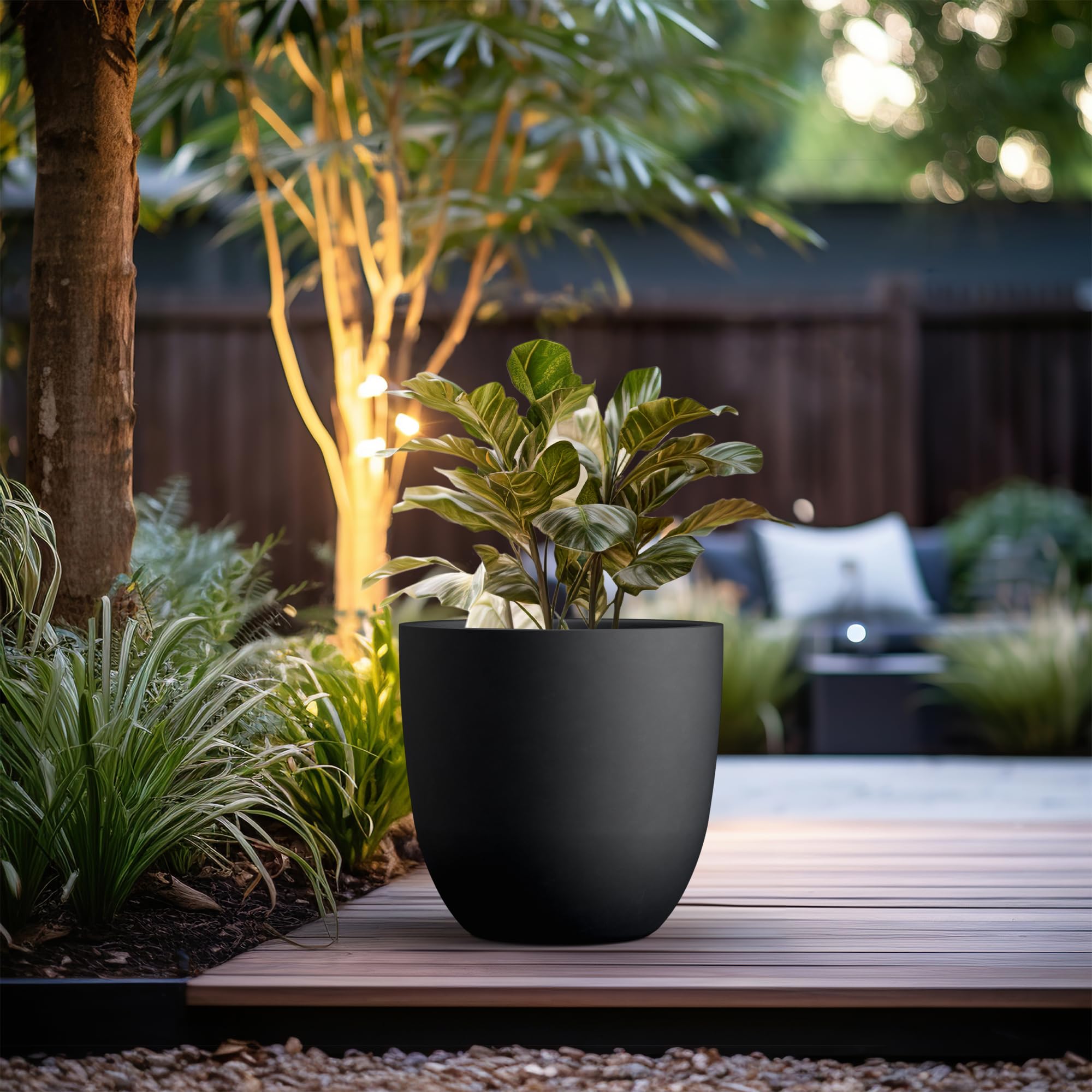 Kante planter on patio with greenery illustrating weather-resistant outdoor use benefit
