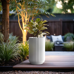 Kante planter on patio with leafy plant demonstrating weatherproof outdoor styling