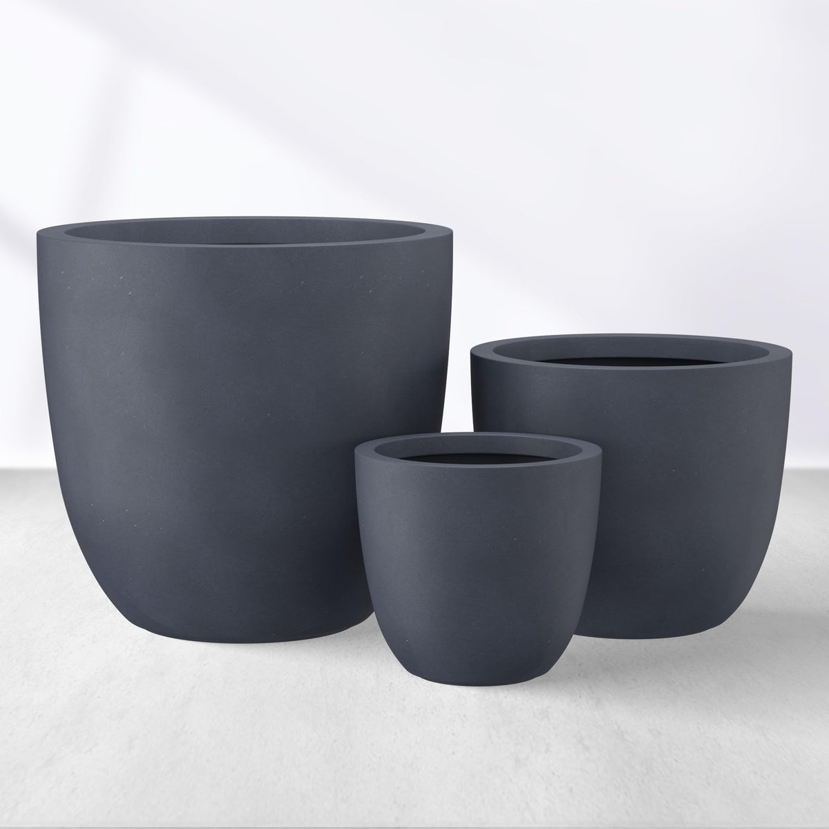 kante front view of three charcoal bowl planters showing modern cohesion and curb appeal