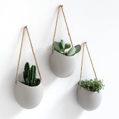 Kazai Ellie front view showing three matte light gray planters for neat wall display