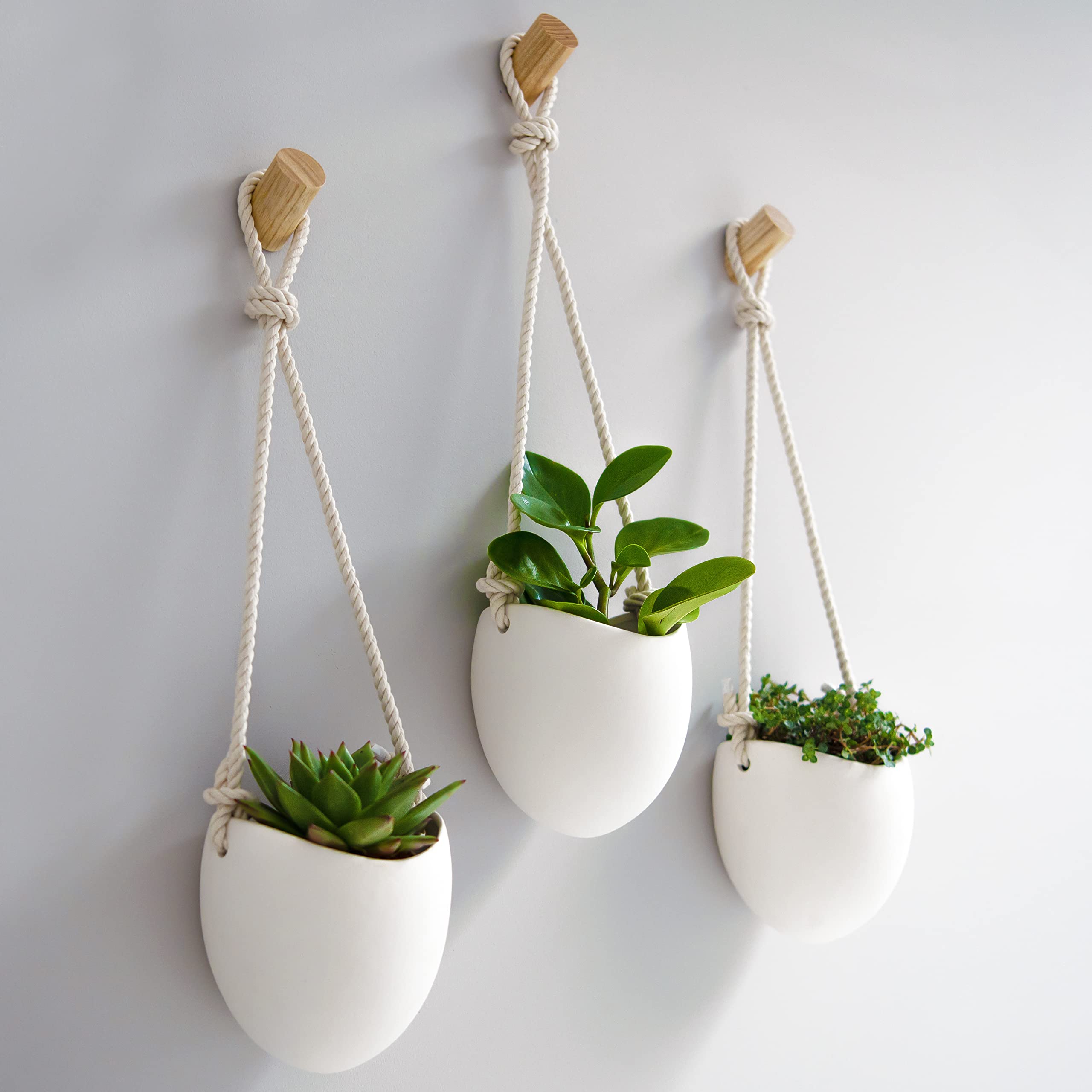 Kazai front view of three matte white porcelain vases highlighting clean modern lines and cohesion