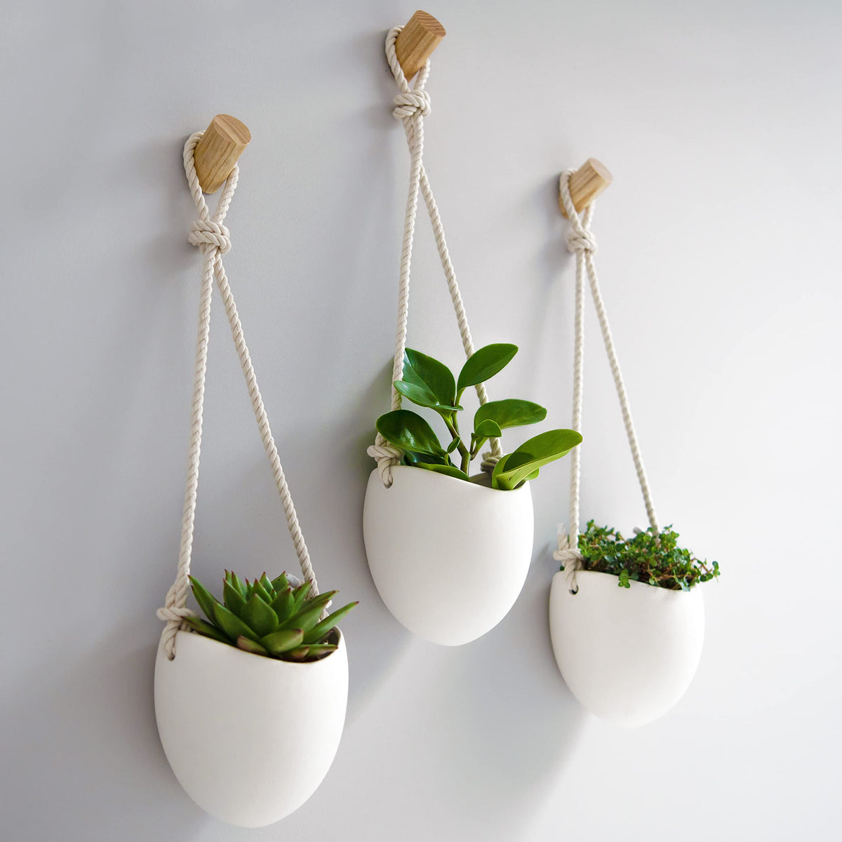 Kazai front view of three matte white porcelain vases highlighting clean modern lines and cohesion