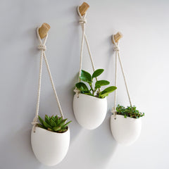 Kazai front view of three matte white porcelain vases highlighting clean modern lines and cohesion