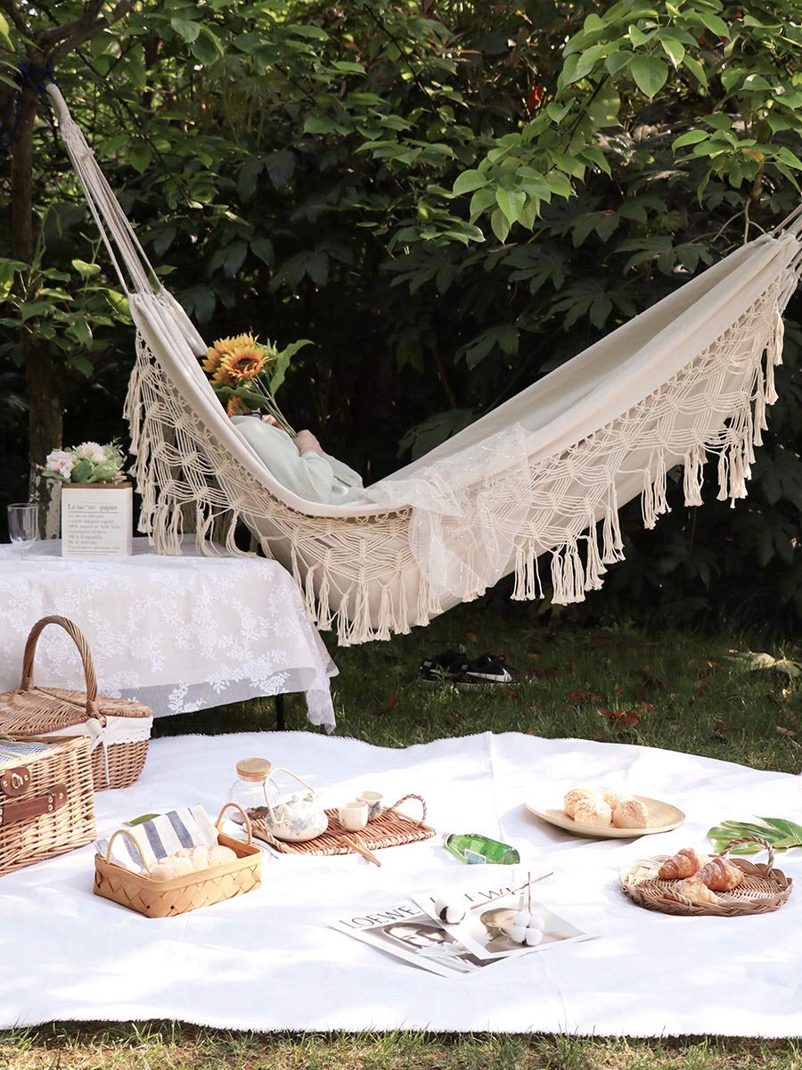 KEREITH hammock hung between trees at the beach for portable relaxation