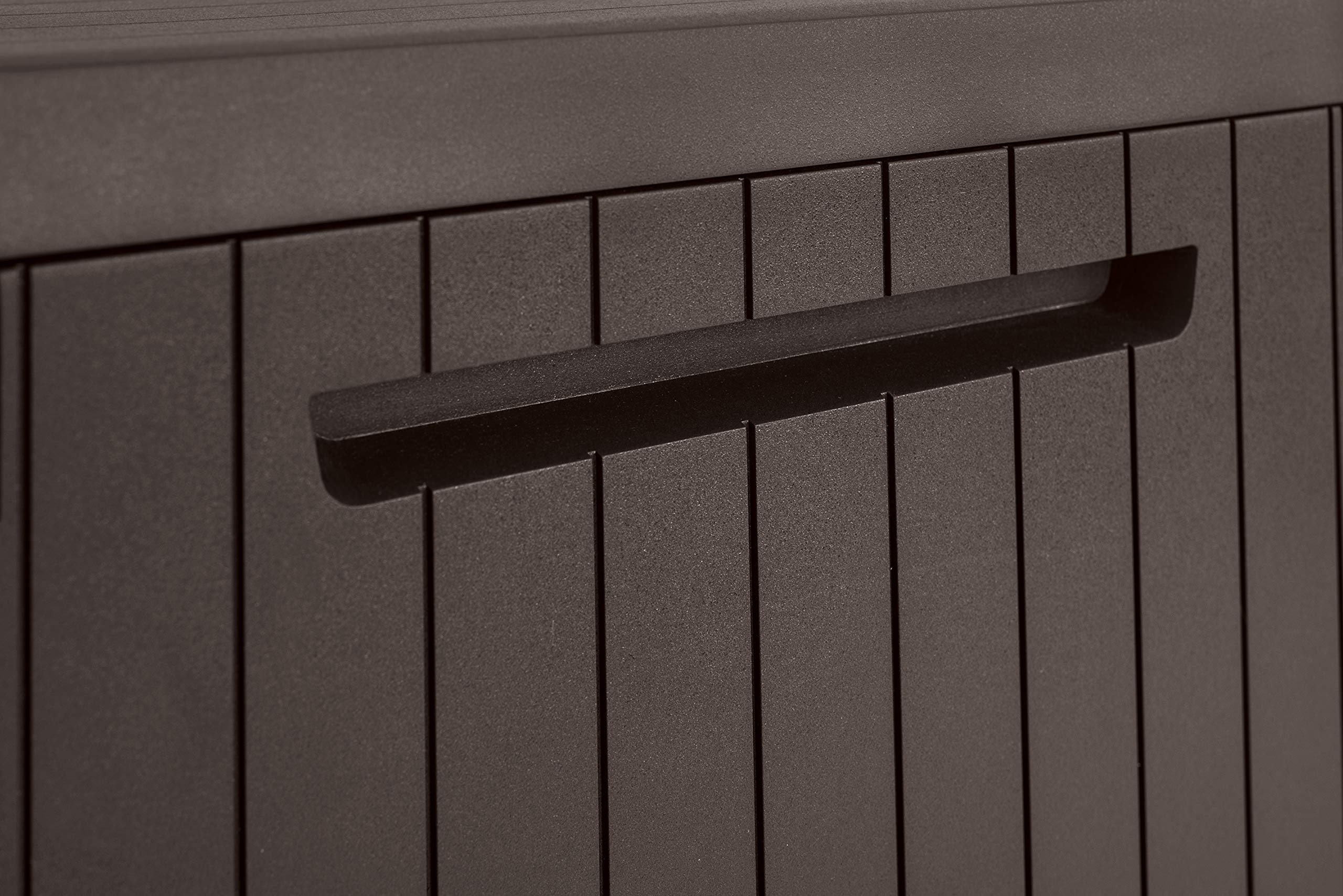 Keter City next to chair for scale showing compact dimensions suitable for small patios