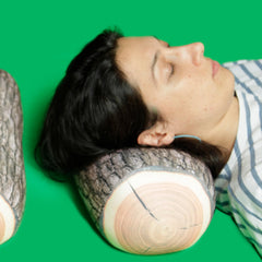 Kikkerland pillow supporting neck in use for portable comfort during travel