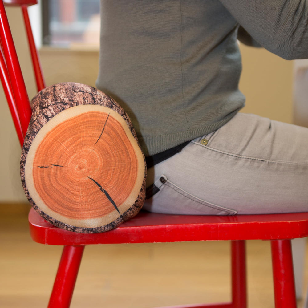 Kikkerland log head rest styled on shelf adding whimsical decor and warmth