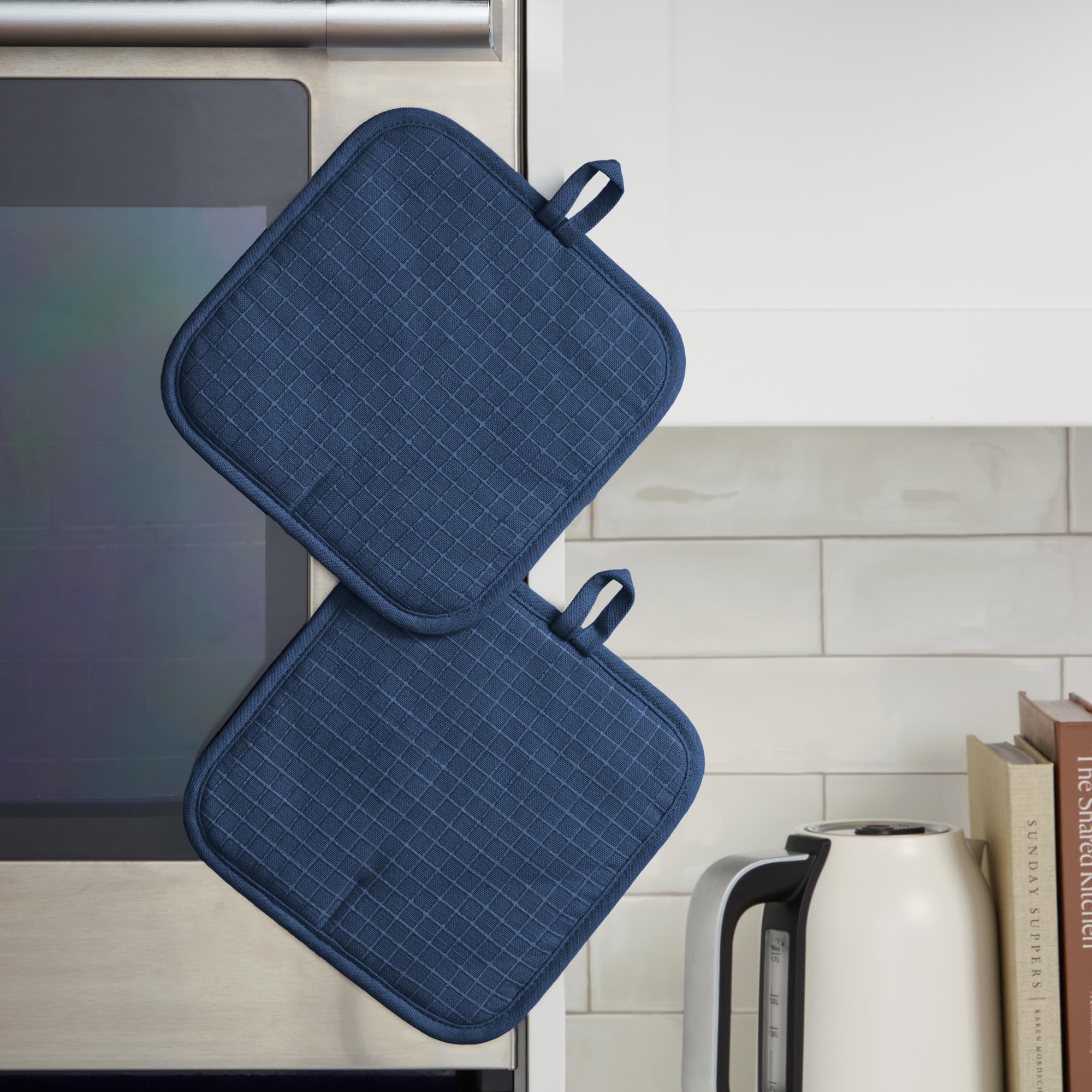 KitchenAid pot holder gripping a hot skillet offering secure, steady hold