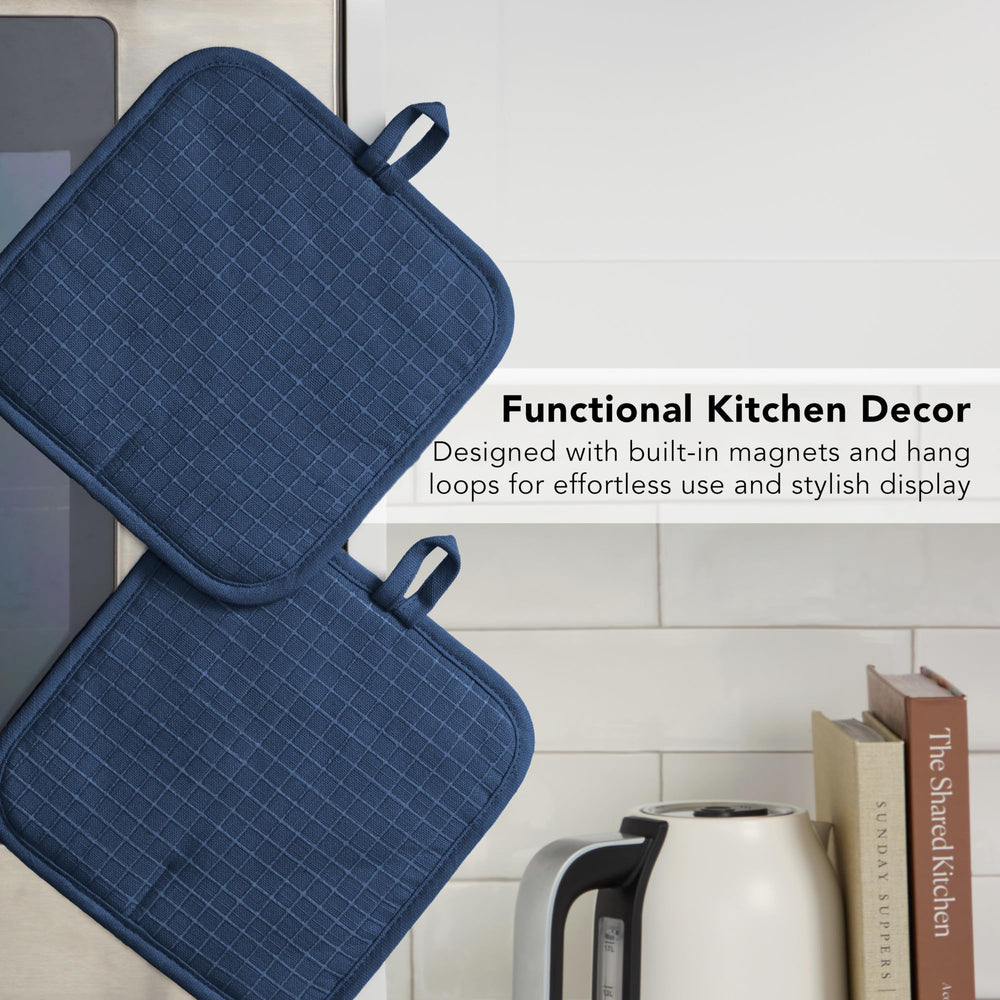 KitchenAid pot holder beside ruler showing compact 8 by 8 inch size