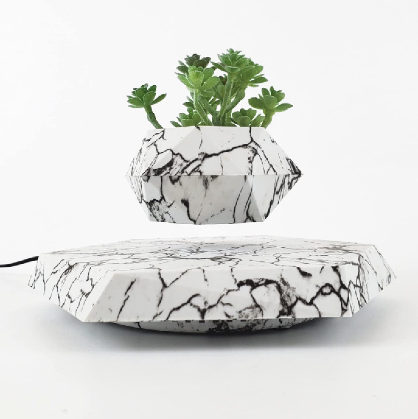 KIYOMING pot rotating atop base showing 360-degree viewing benefit