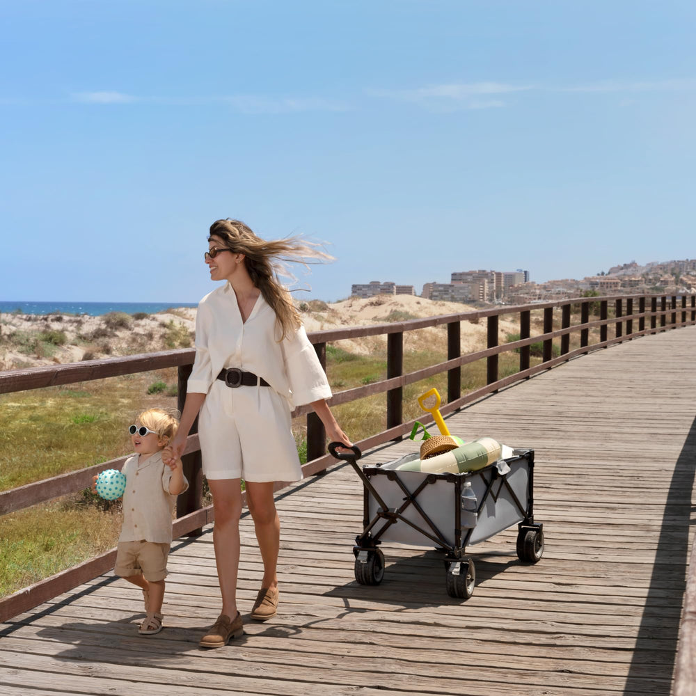 kk Kinderkraft ROLLSTER in use on beach carrying chairs and cooler for effortless outings