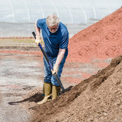 KOLEIYA pitchfork in use moving mulch demonstrating faster material handling