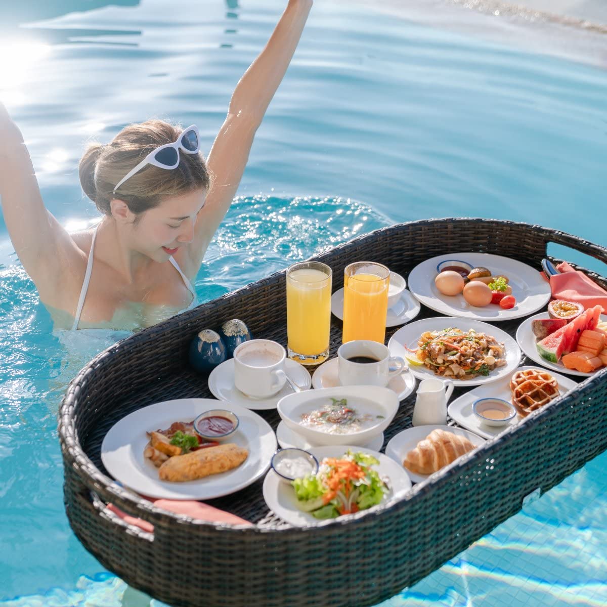 Kordes tray floating in pool with food and drinks, creating relaxed backyard ambience