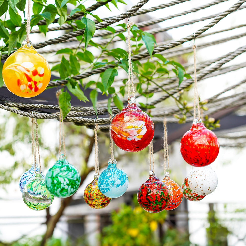 KRISININE gazing balls suspended in a garden gazebo bringing color to outdoor space