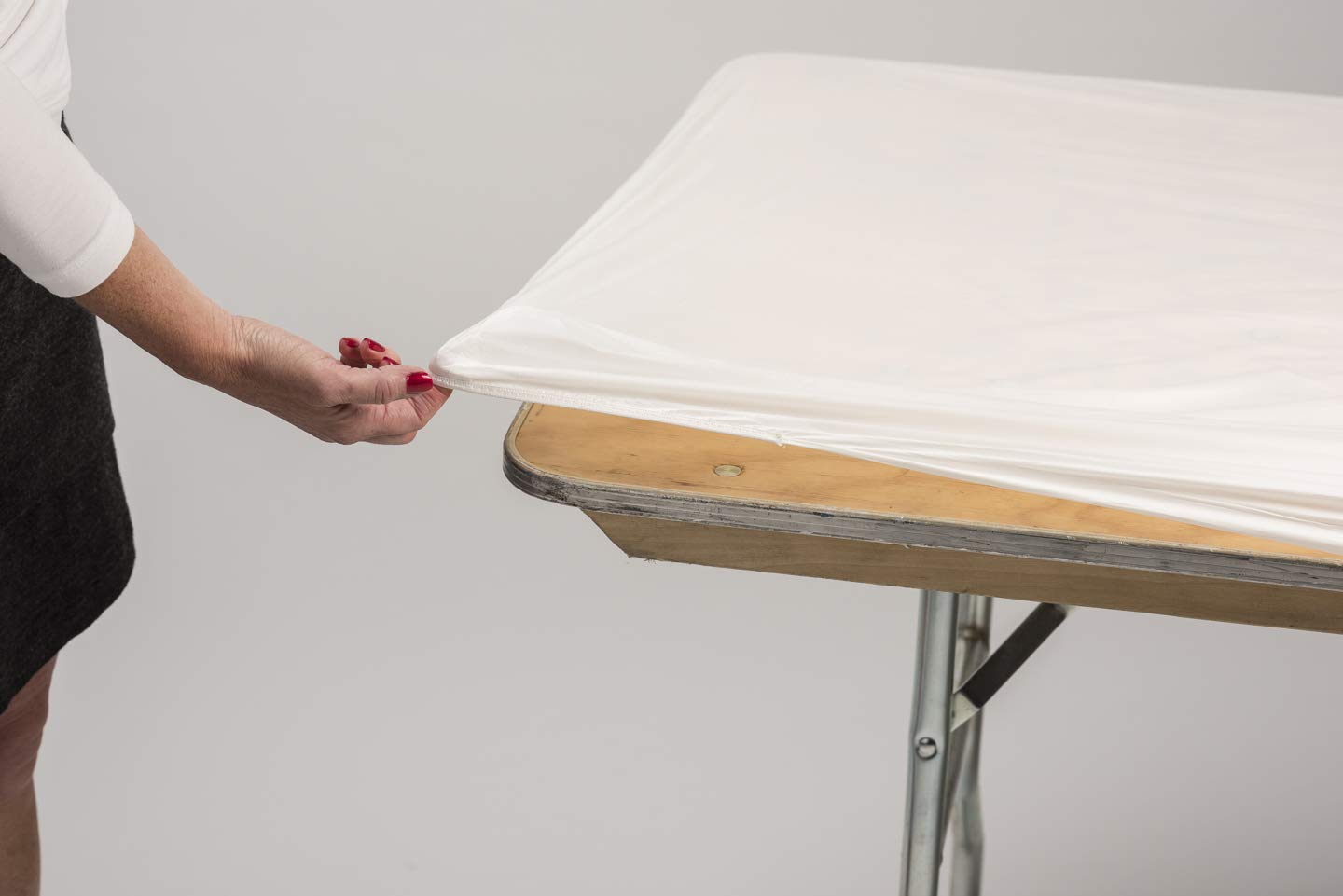 Kwik-Covers stretched on an outdoor 8-foot table showing tidy, wind-resistant protection