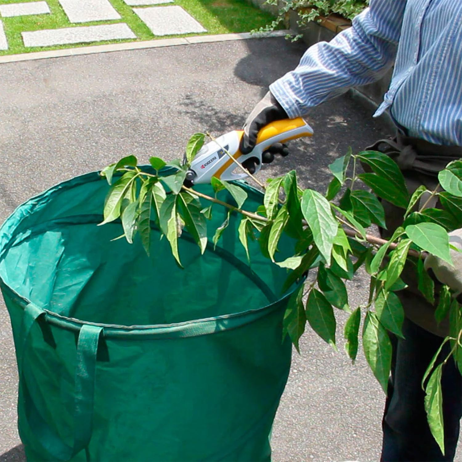 KYOCERA RYOBI in garden setting showing efficient pruning of shrubs and fruit trees