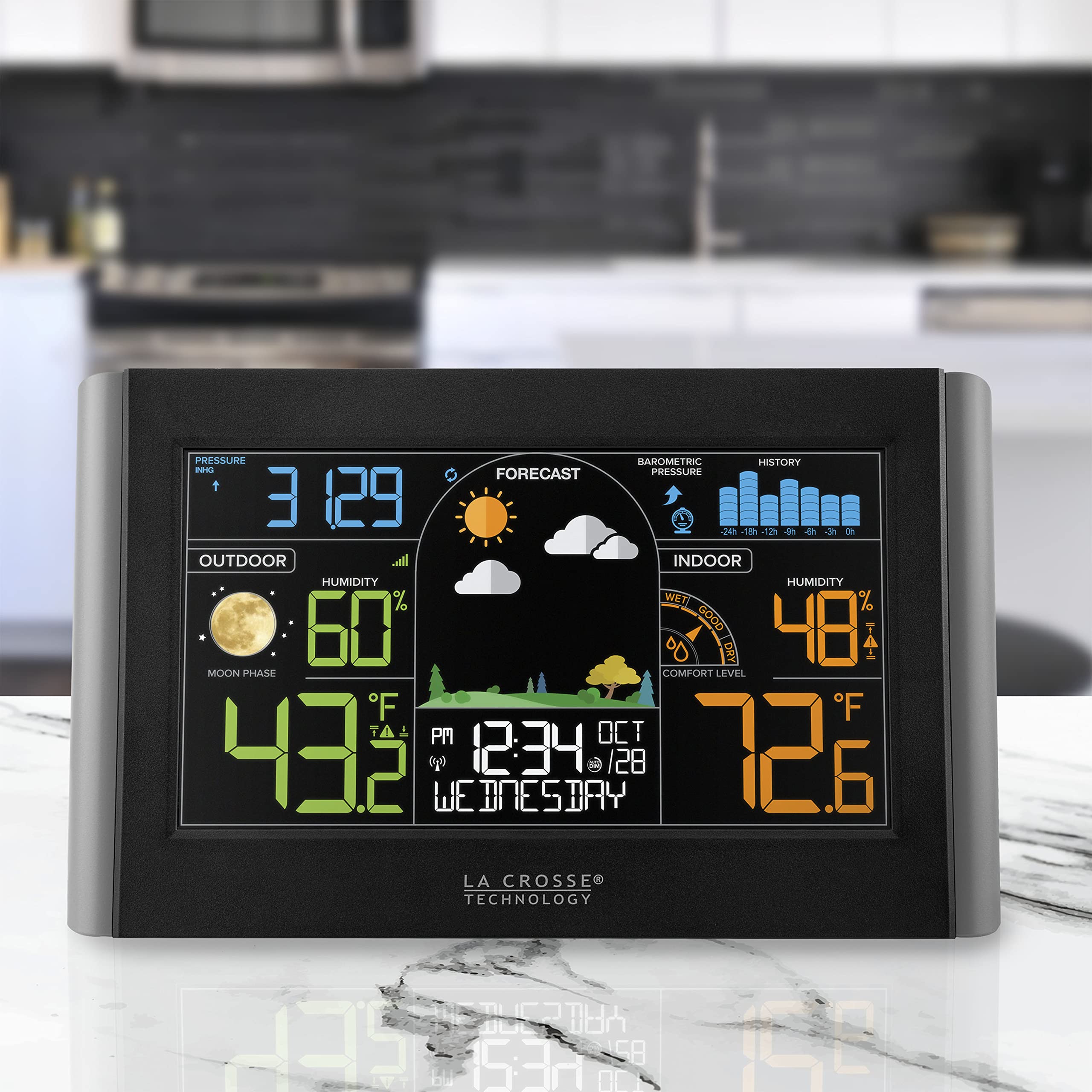 La Crosse Technology mounted on wall above table demonstrating home monitoring convenience