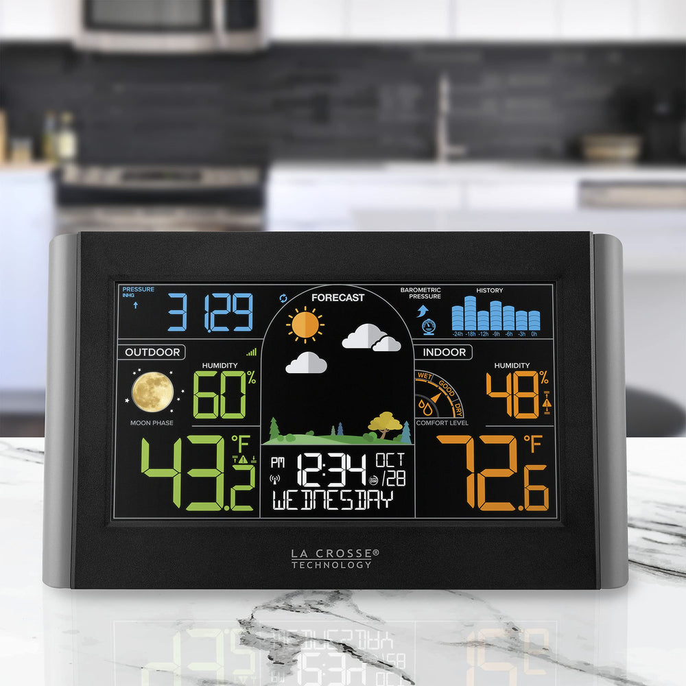 La Crosse Technology mounted on wall above table demonstrating home monitoring convenience