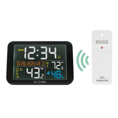La Crosse Technology on a nightstand with alarm set offering bedside climate visibility